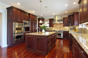 Renewed kitchen with wooden floors and granite countertops