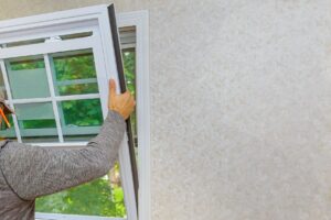 Person installing a window on a home